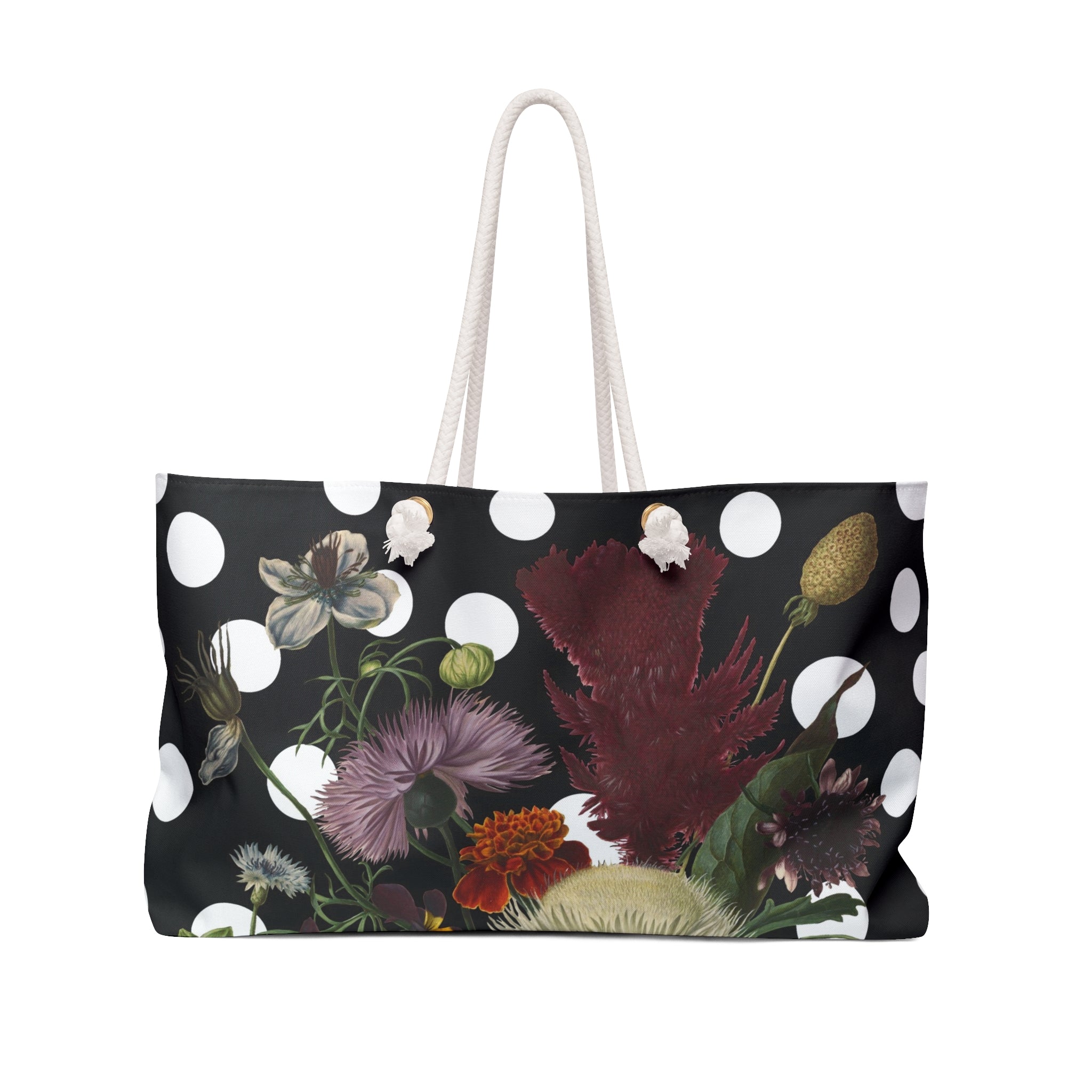 A black weekender tote bag with a floral pattern and white polka dots, featuring a white rope handle.
