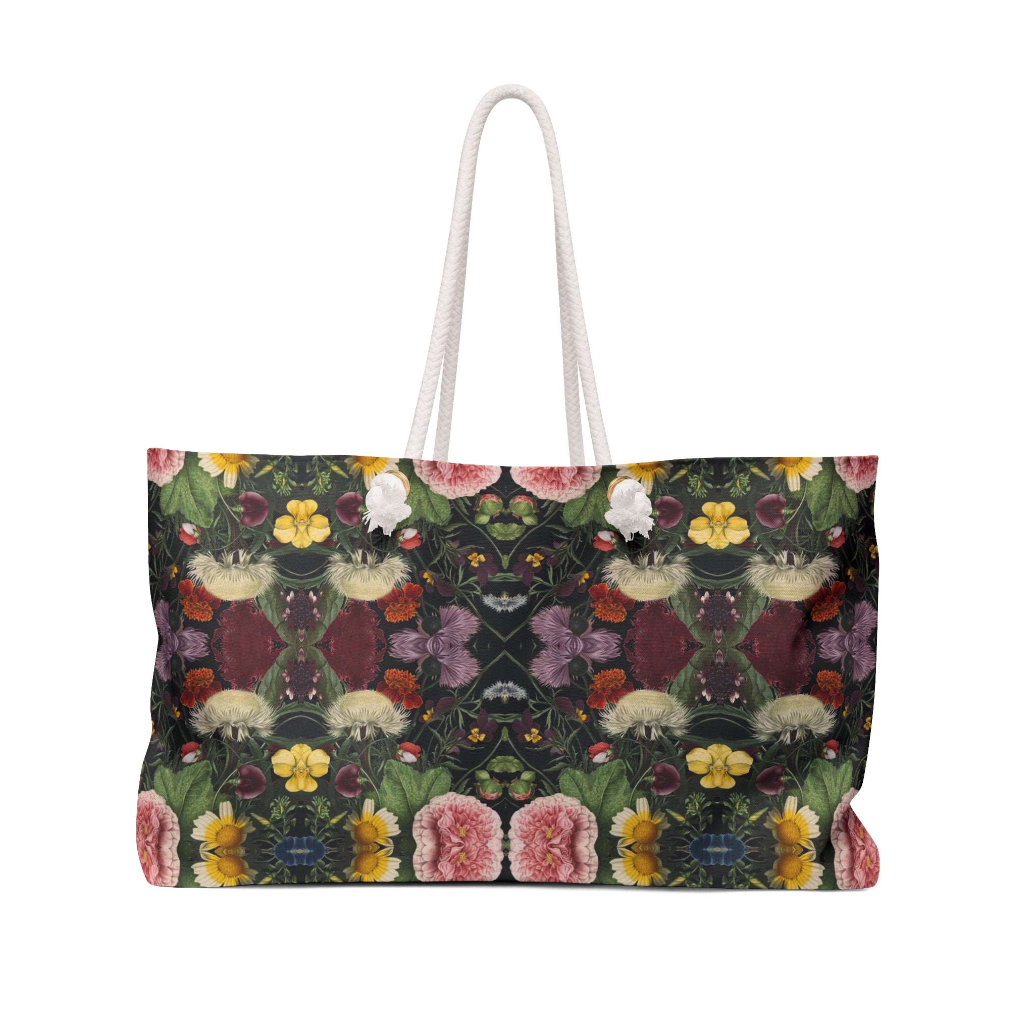 A weekender tote bag with a floral pattern in multiple colors on a black background, featuring white rope handles.