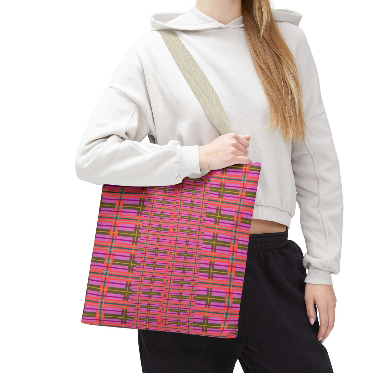A vibrant pink and green plaid tote bag with a beige shoulder strap perfect for everyday use