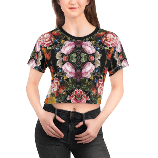Woman wearing a colorful floral crop top on a white background