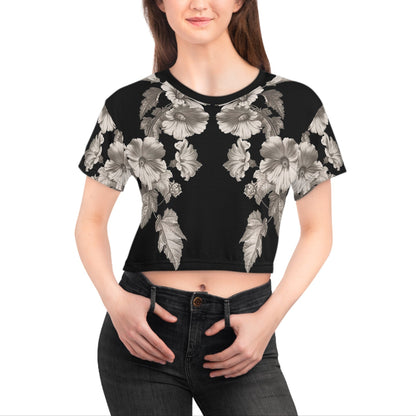 Woman wearing a black floral crop top on a white background