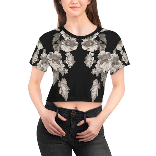 Woman wearing a black floral crop top on a white background