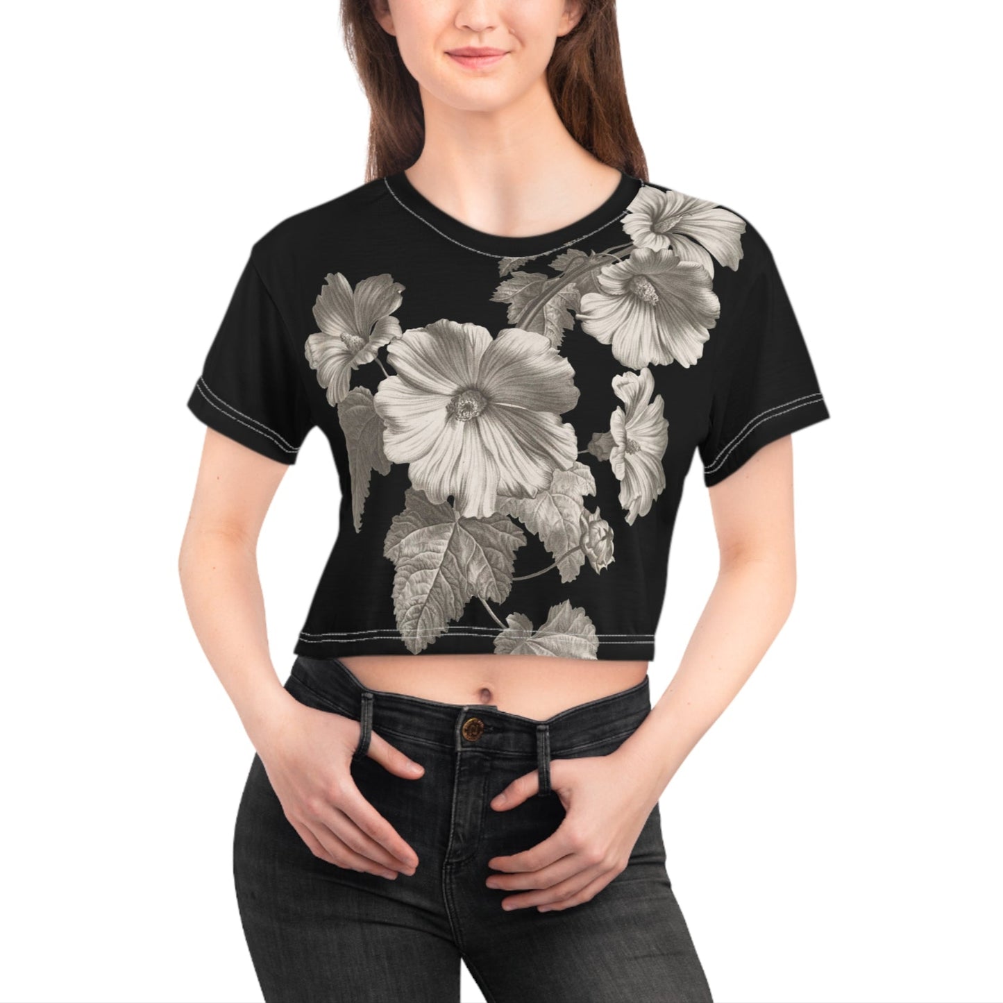 Woman wearing a black crop top with floral designs on a white background