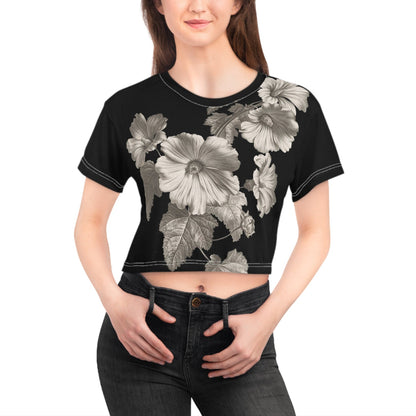 Woman wearing a black crop top with floral designs on a white background