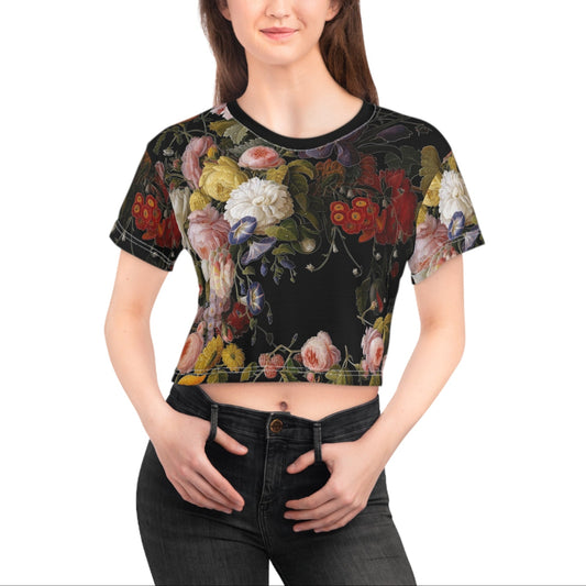 Woman wearing a black floral crop top on a white background