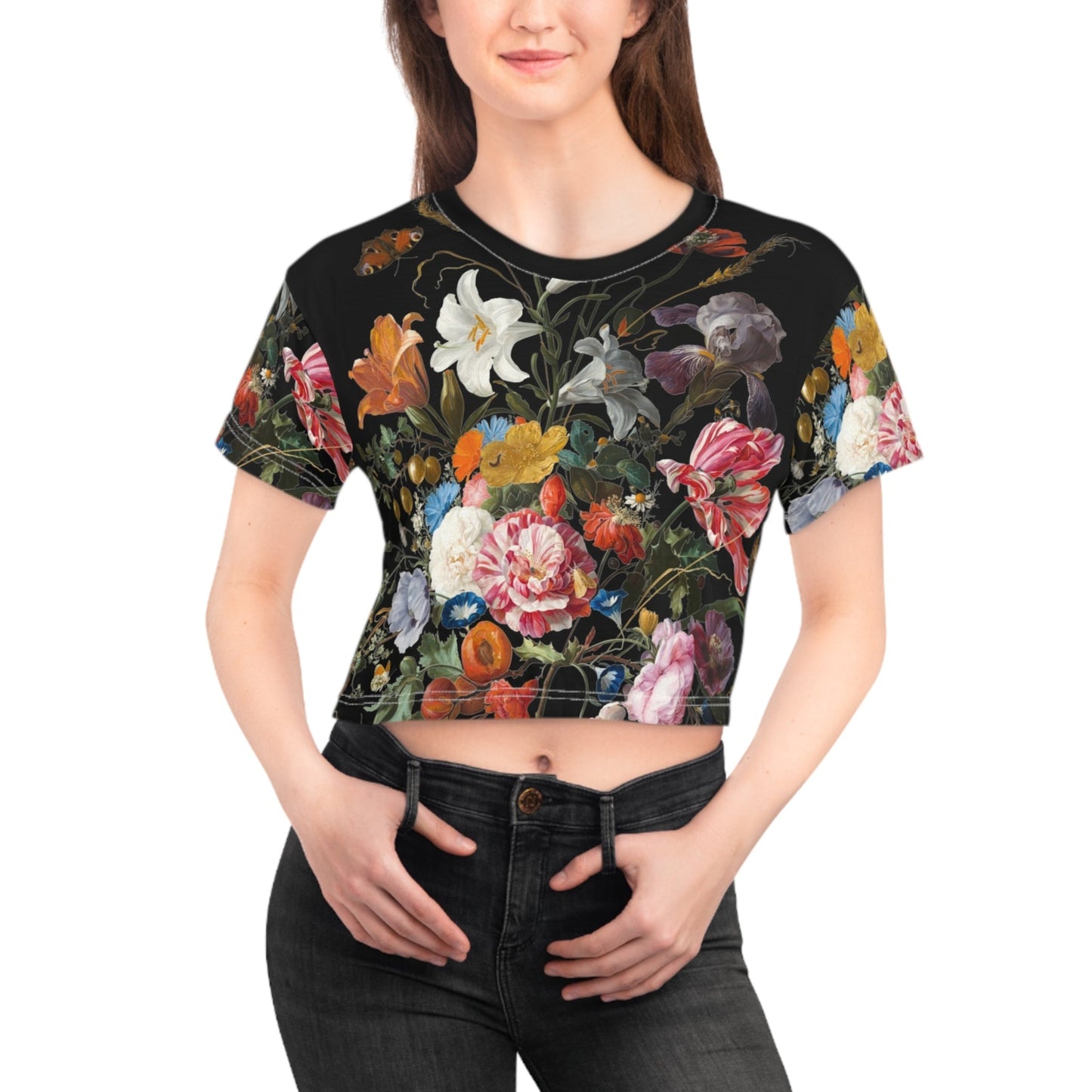 Woman wearing a black crop top with colorful floral design on a white background