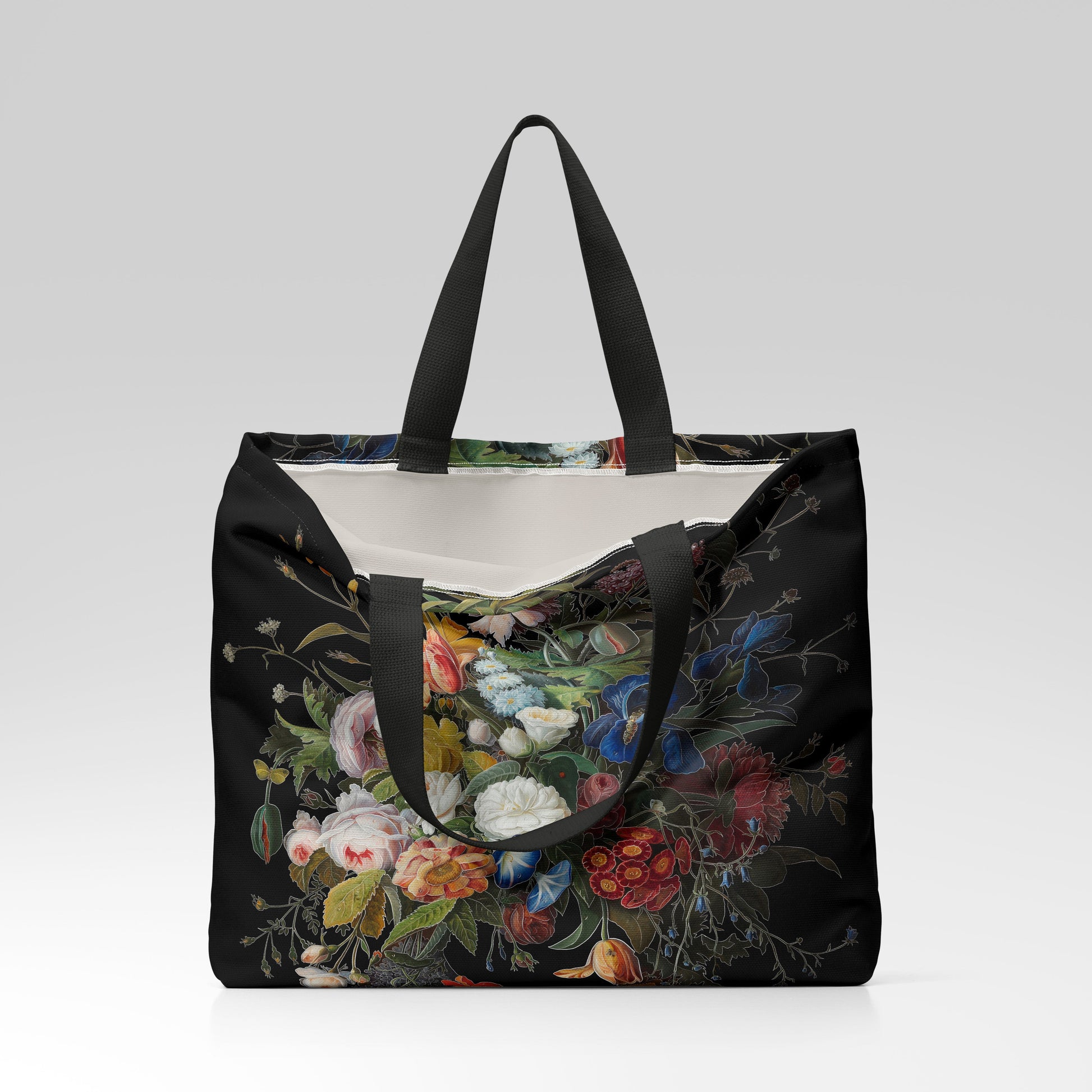 Floral-patterned tote bag with black handles on a light gray background