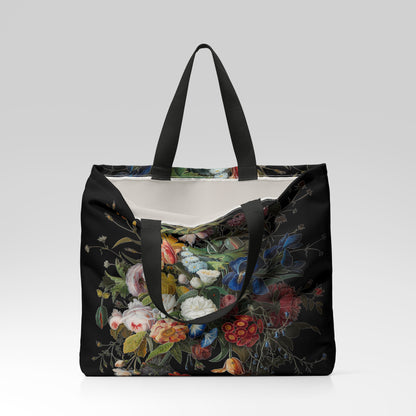 Floral-patterned tote bag with black handles on a light gray background