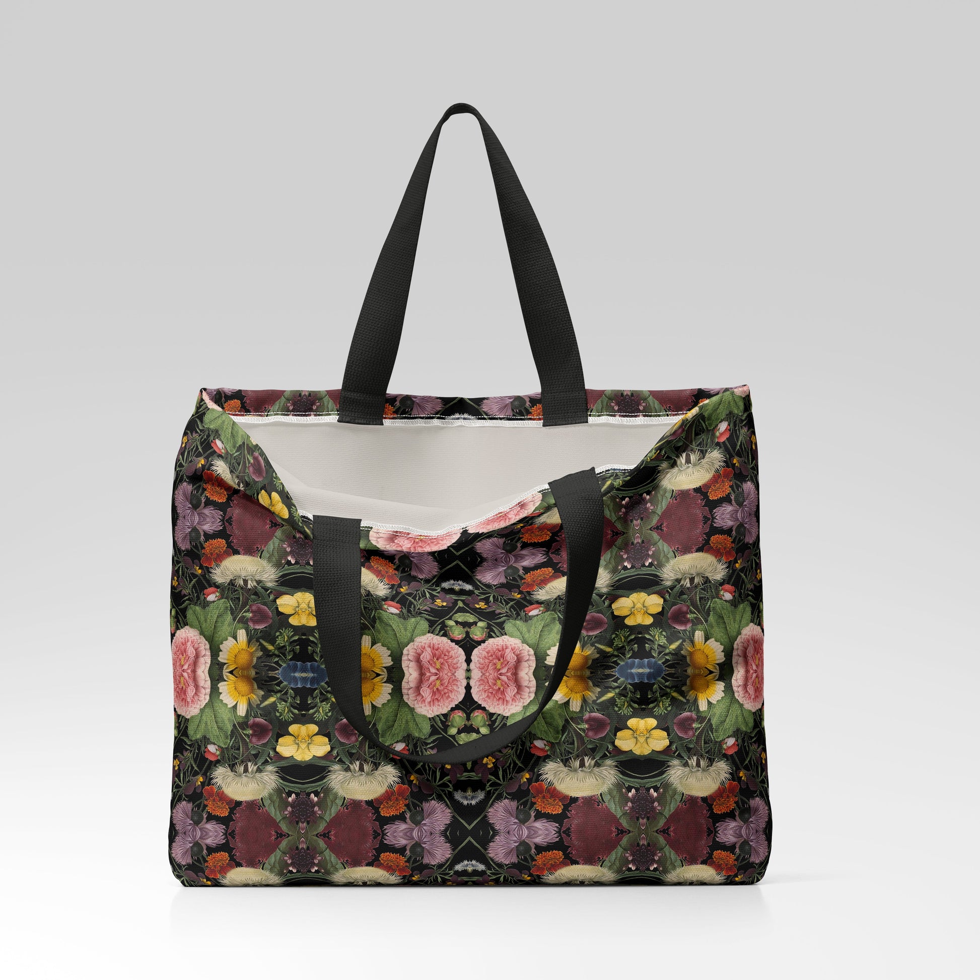 Floral patterned tote bag with black handles on a light gray background