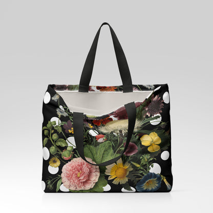 Floral-patterned tote bag with black handles on a light gray background
